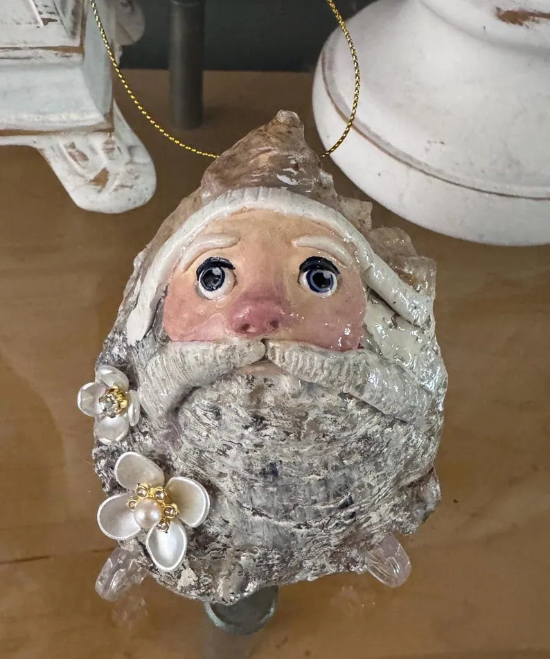 Seaside Santa hand sculpted on an oyster shell with dimensional flowers