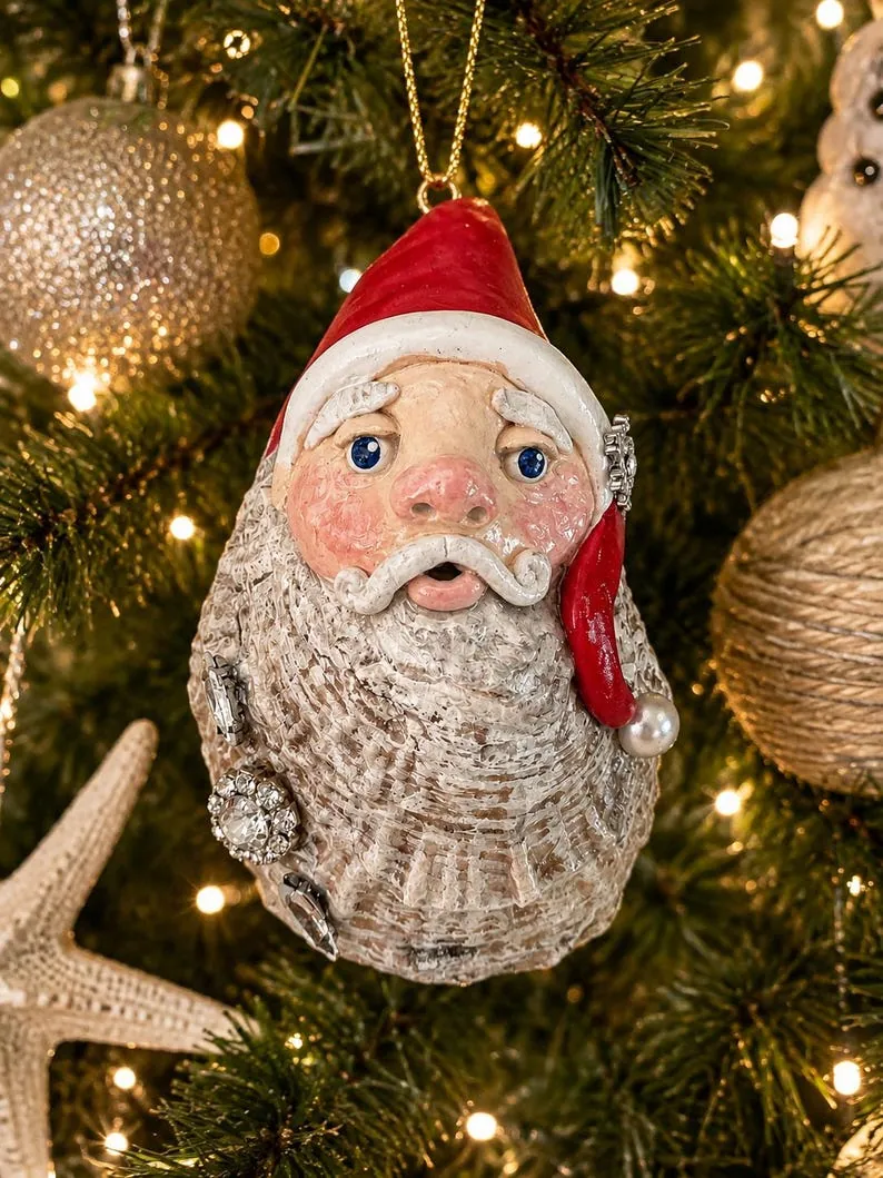 Hand sculpted Santa on an oyster shell with rhinestone accent