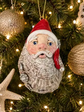 Hand sculpted Santa on an oyster shell with rhinestone accent